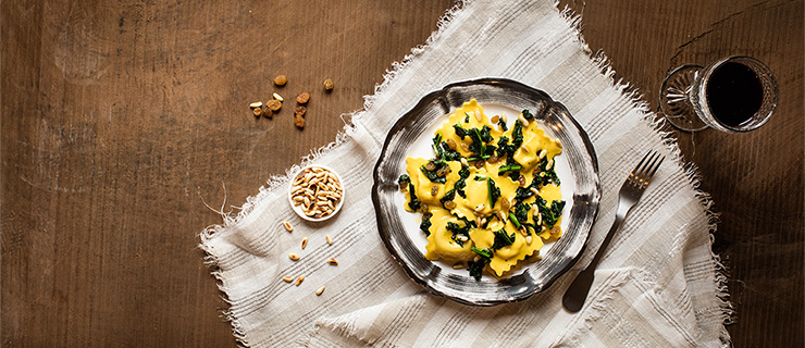 Spinach & Ricotta Ravioli with Kale, Golden Raisins, Pine Nuts and Parmesan