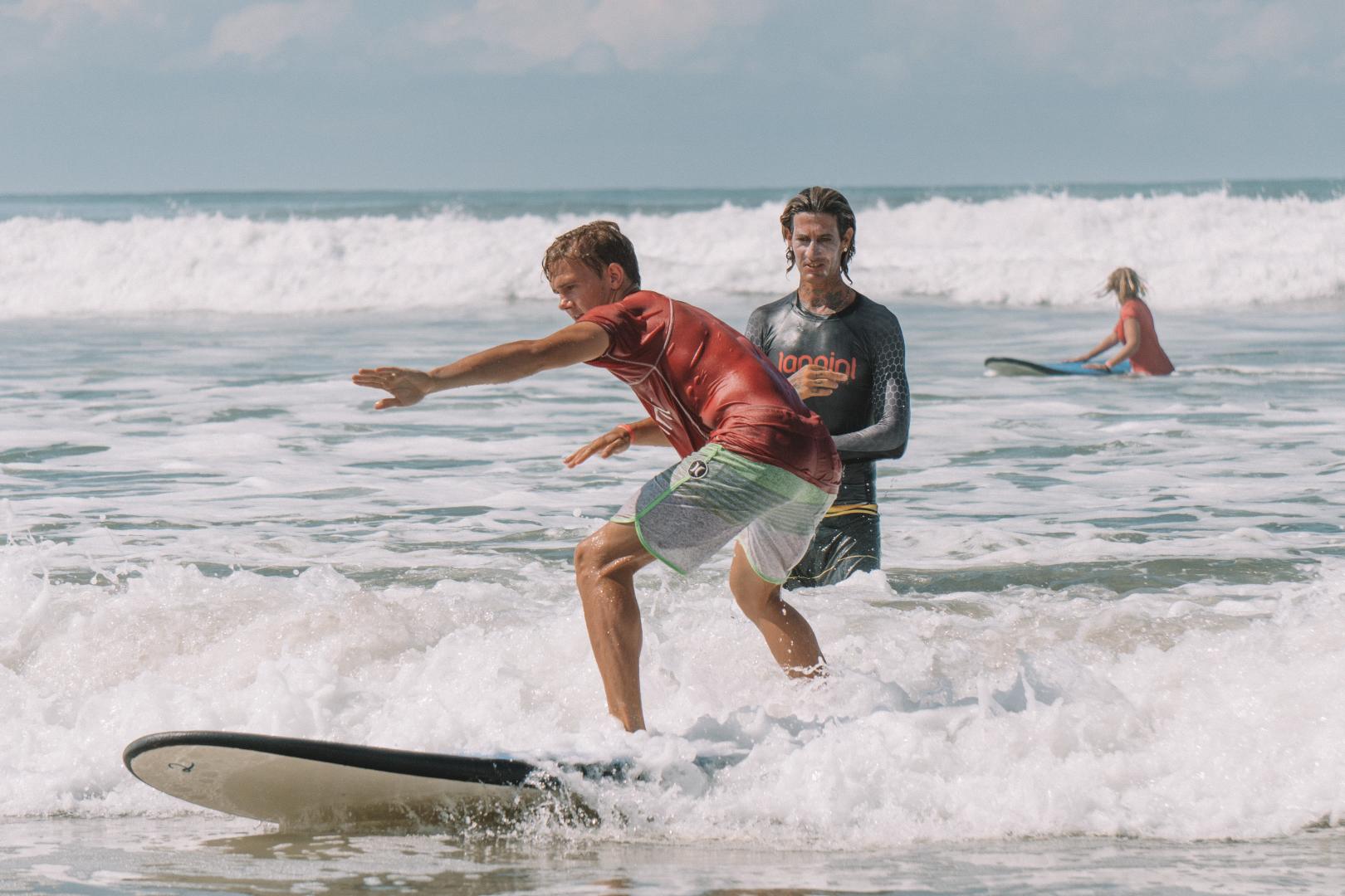 Beginner surfer with instructor