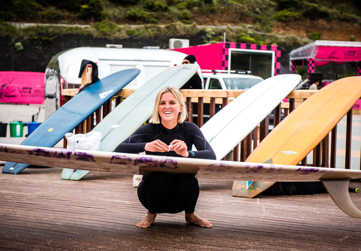 Surfer waxing board in Ericeira