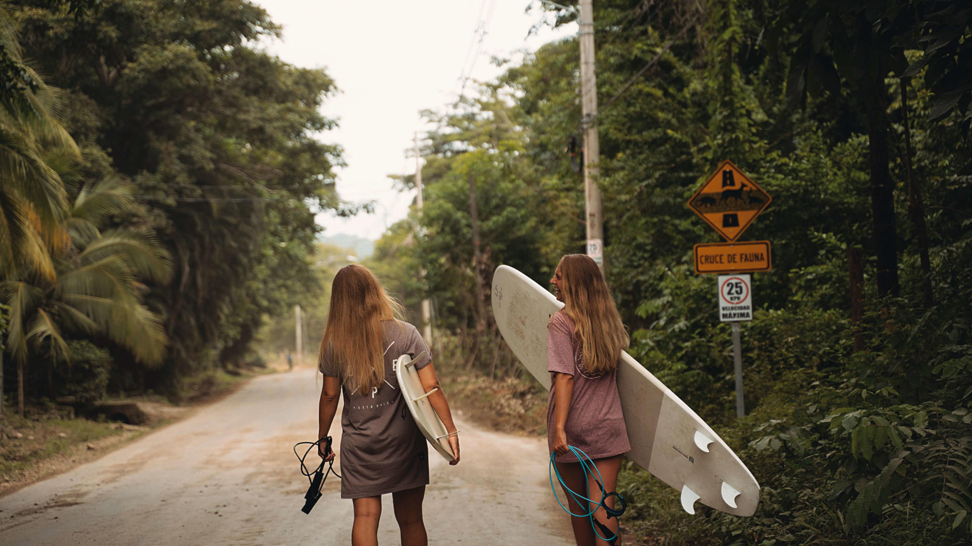 Girls carrying board in Santa Teresa, Costa Rica