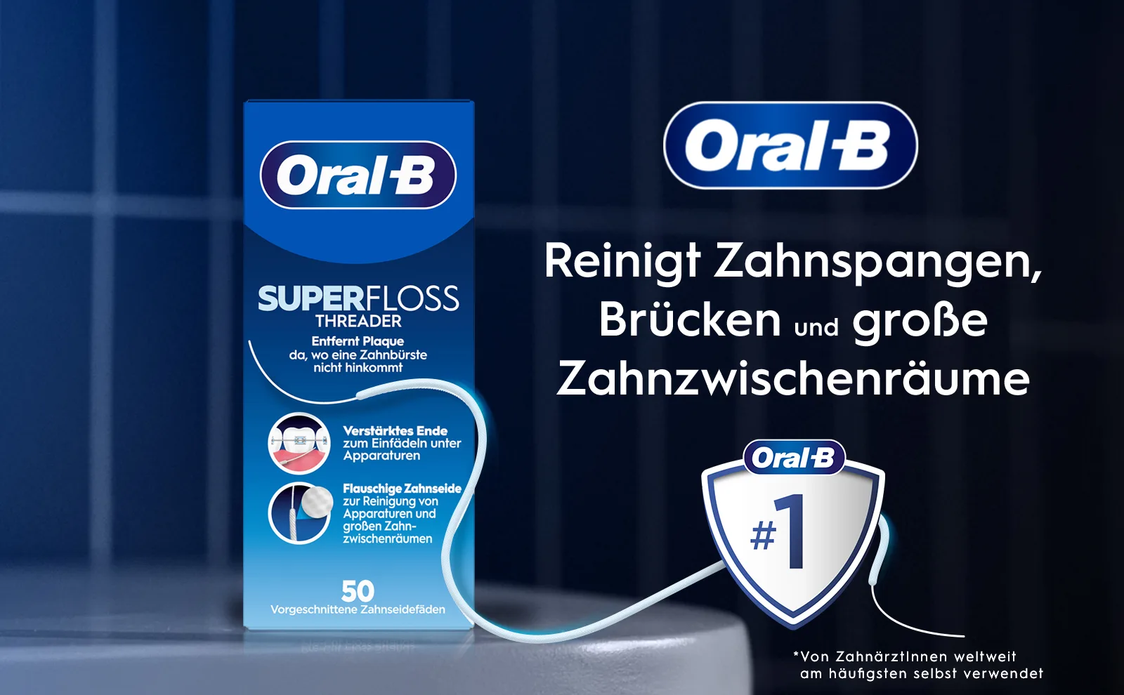 Produktabbildung in der linken Ecke zeigt die  Zahnseide. Logo von Oral-B und ein silbernes Schutzschildsymbol mit einer blauen Zahl Eins vor blauem Hintergrund			 