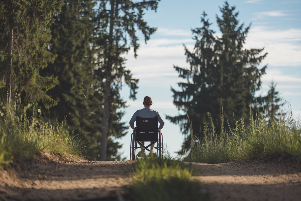 Silhouette of a person in wheel chair