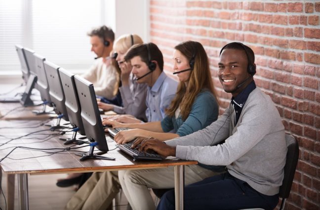 Young Call Center Team Talking With Customers