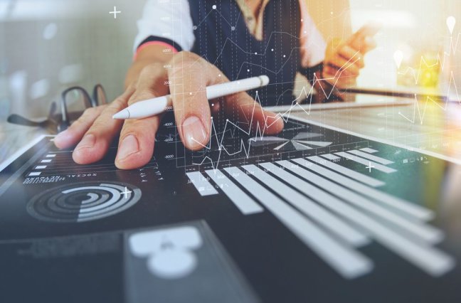 business documents on office table with smart phone and digital tablet and graph finance with social network diagram and man working in the background