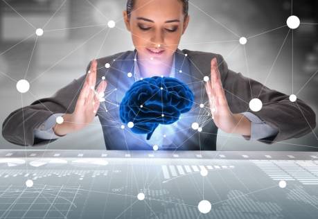Woman holding imaginary brain above data workspace