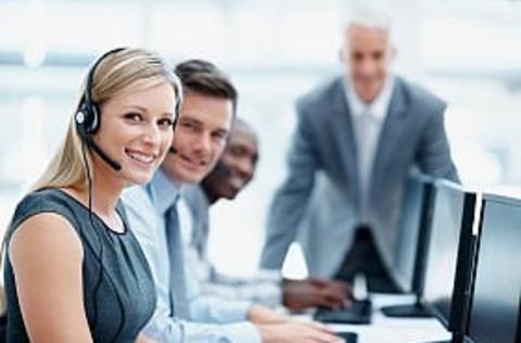 Young, motivated business team with manager at a call center