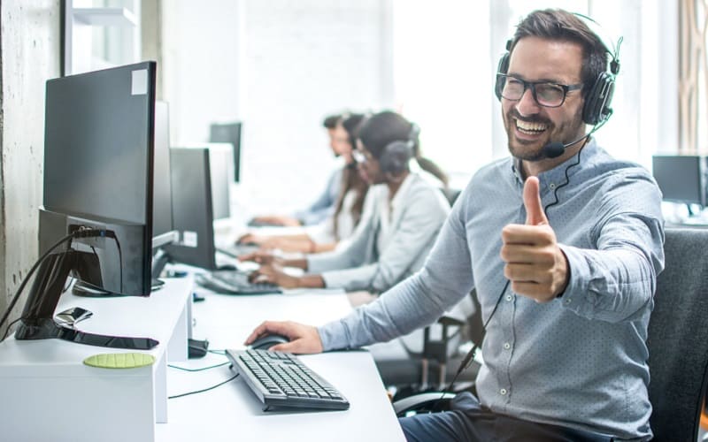 Man smiles with headset on 