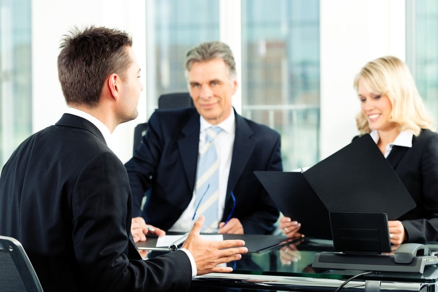 professionals interviewing man
