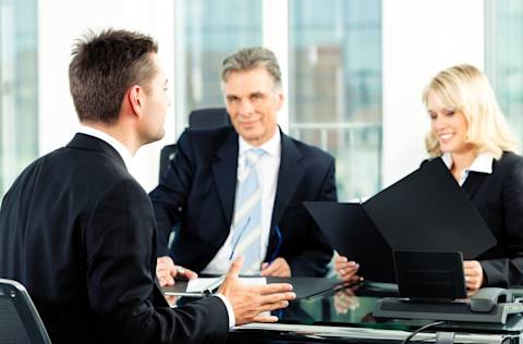 professionals interviewing man