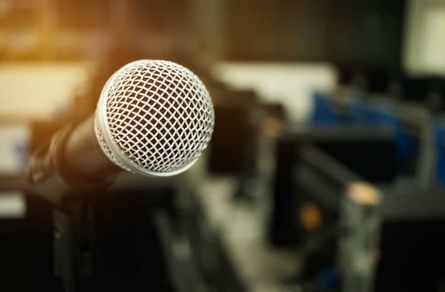 Microphone on abstract blurred of speech in seminar room