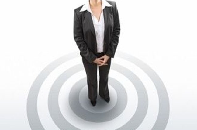 Business woman standing on bullseye