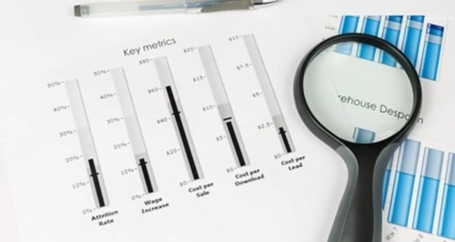 papers with key metrics and magnify glass 