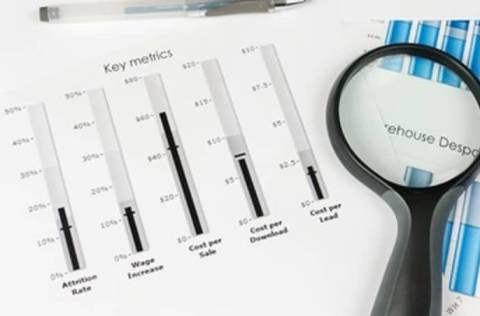papers with key metrics and magnify glass 
