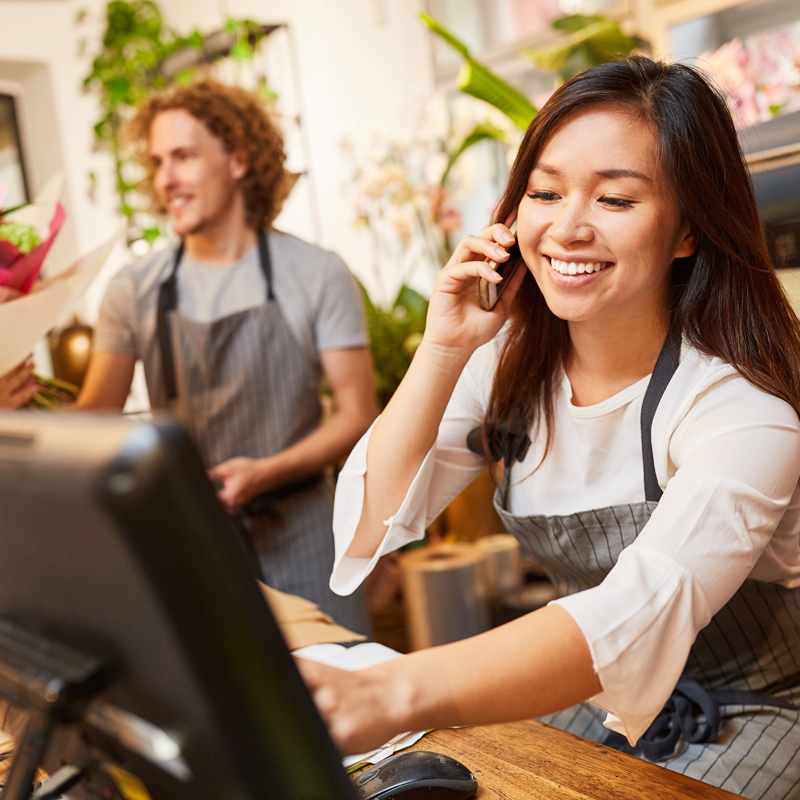 Woman smiles while taking phone call
