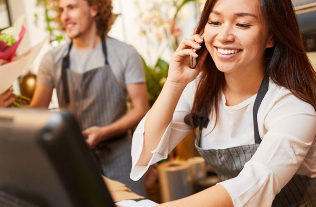 Woman smiles while taking phone call