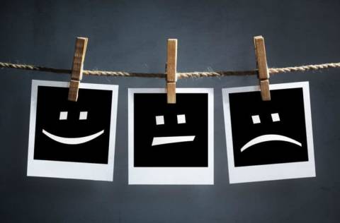 Polaroid photos showing happy face, neutral face, sad face