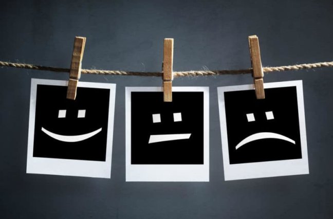Polaroid photos showing happy face, neutral face, sad face