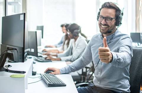 Happy call center agent giving the thumbs up