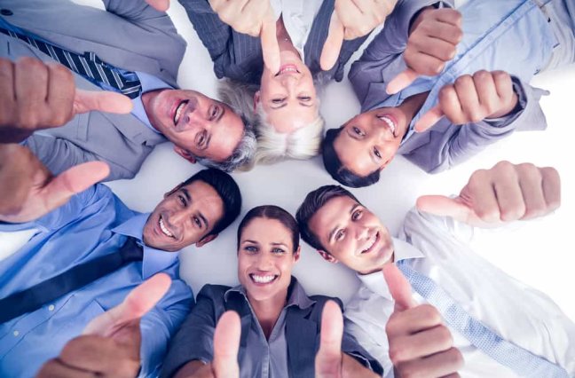 Business people gesturing thumbs up on white background