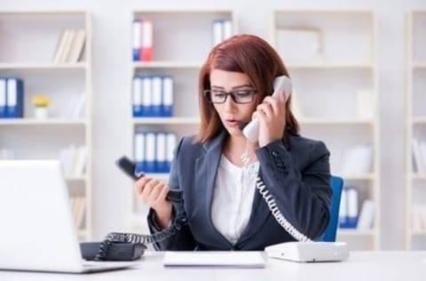 Woman stressed holding two phones