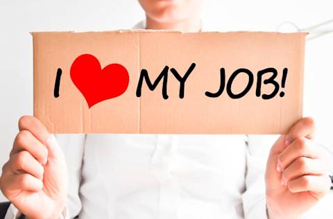 Woman holding sign that reads I love my job