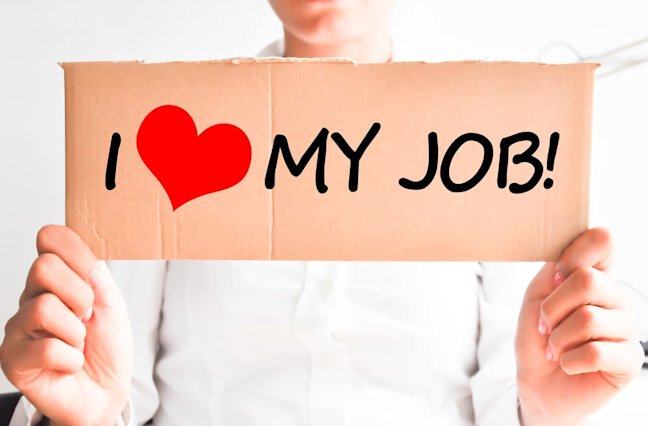 Woman holding sign that reads I love my job