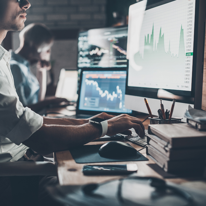 Employee typing at computer desk.