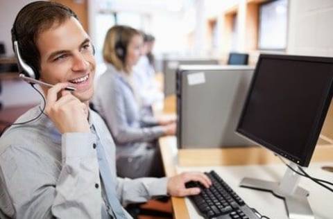 Man on phone working at a call center.