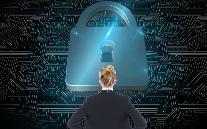 Woman looking at graphic of circuit board with padlock 