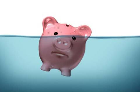Piggy bank sinking into water