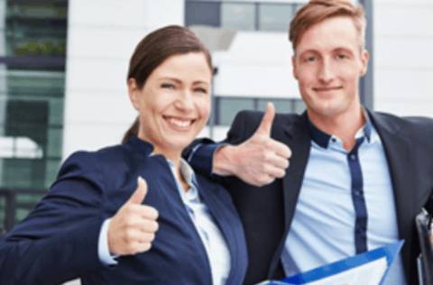 Business man and woman smiling giving thumbs up