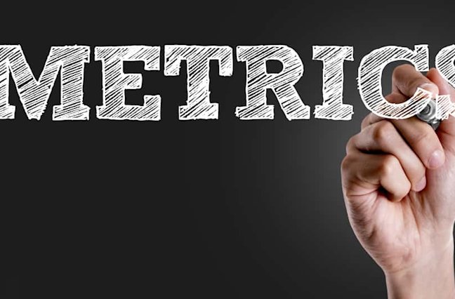 Hand writing "metrics" on screen.