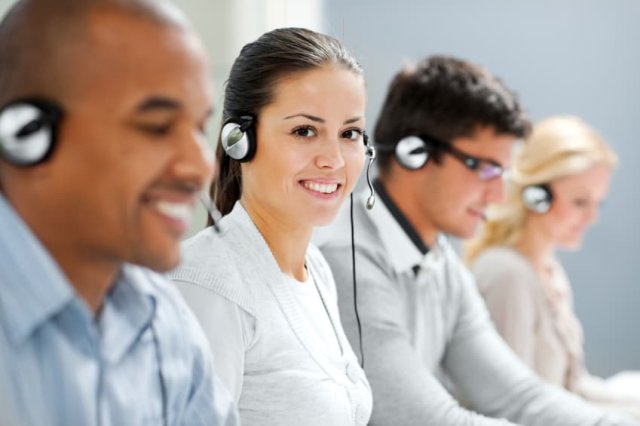 Call center with several smiling agents