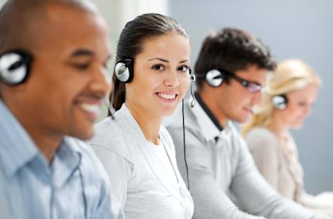 Call center with several smiling agents