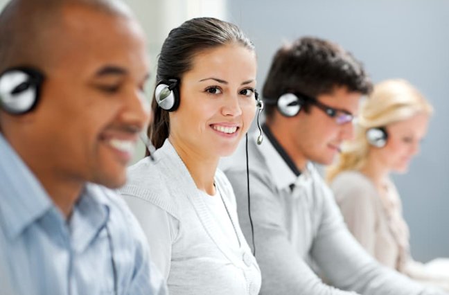 Call center with several smiling agents