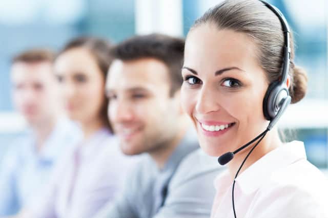 Smiling woman with headset on.
