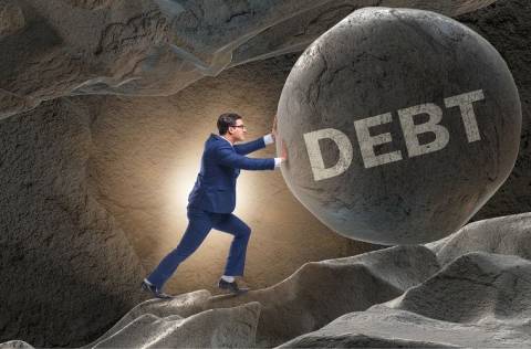 Man pushes boulder uphill, labelled "debt"