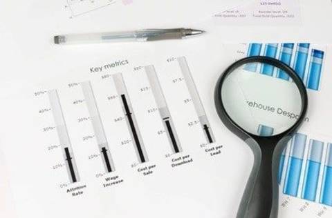Database marketing metrics, papers with key metrics and magnifying glass