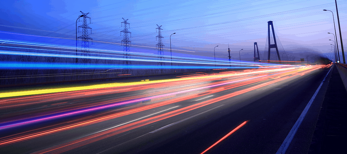 time lapse photo of busy street car lights blur by