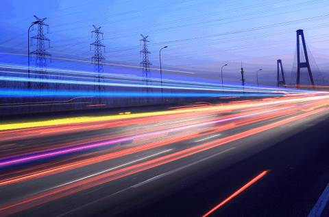 time lapse photo of busy street car lights blur by