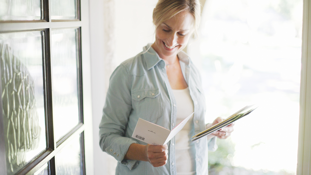 L female checking mail and reading a card