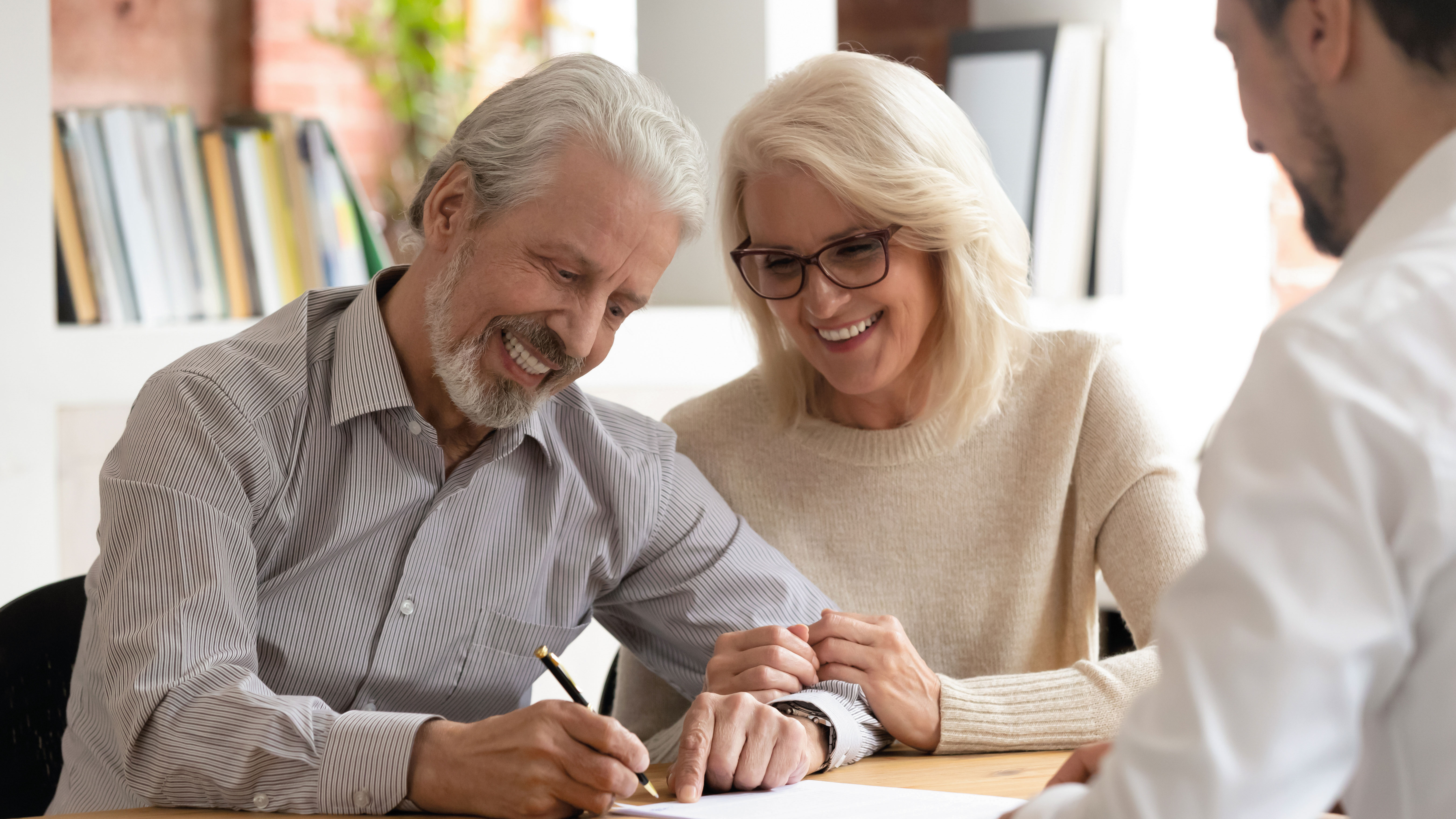 Insurance agent meeting with older couple