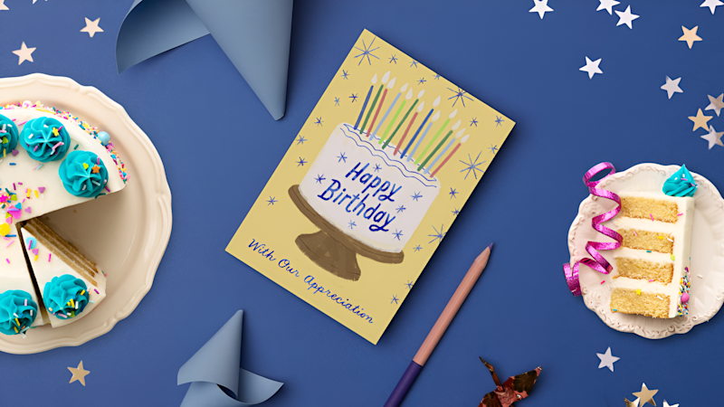What to write in a client birthday card navy table setting with cake and happy birthday card ARTICLE HERO IMAGE