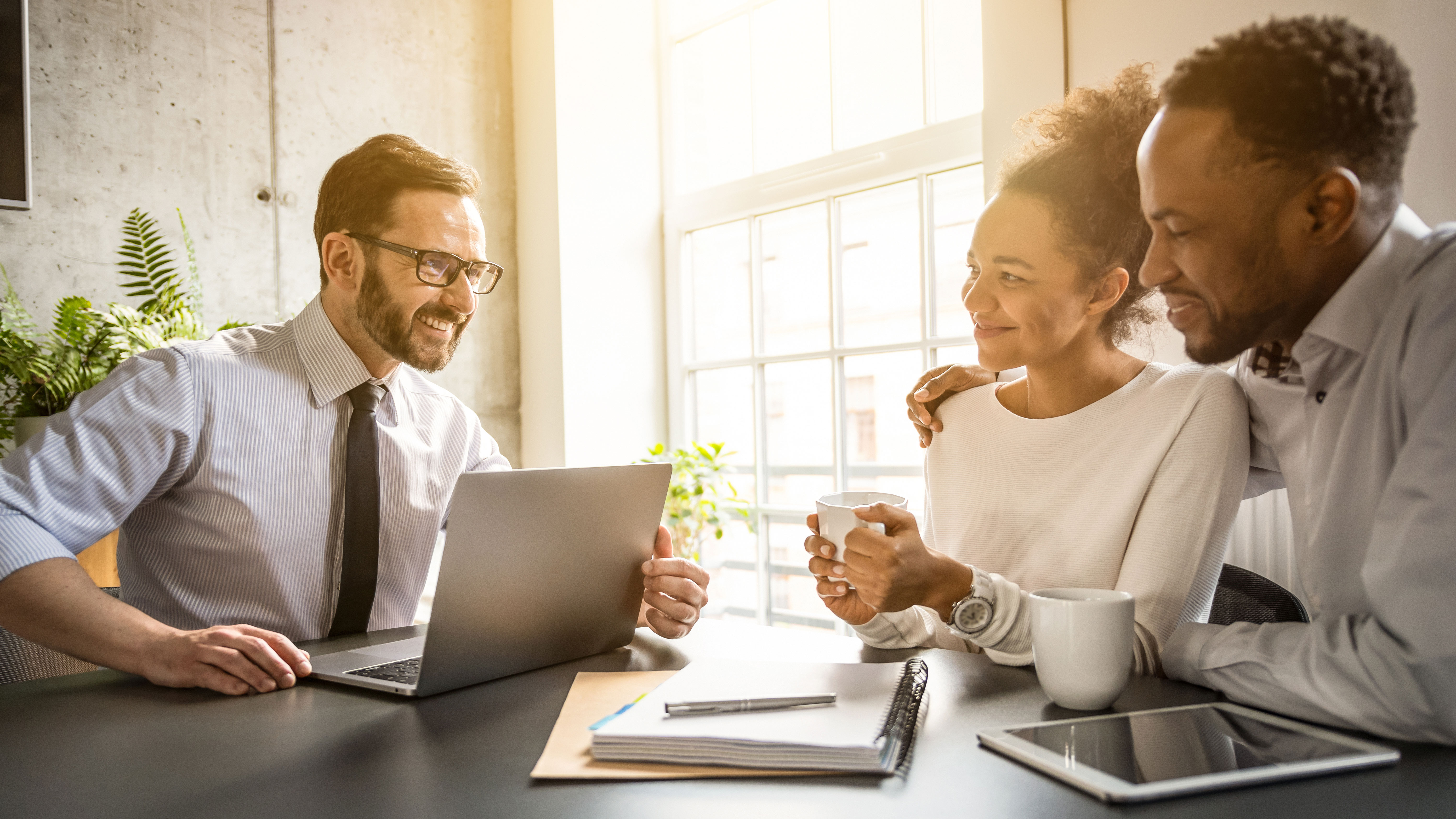 Insurance agent meeting with customers at desk