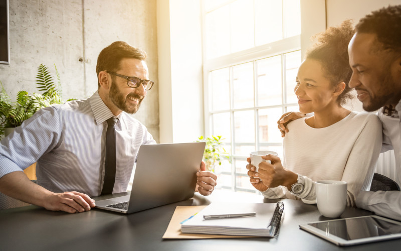 Insurance agent meeting with customers at desk