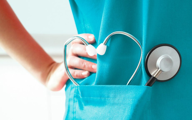 L person in scrubs stethoscope in pocket