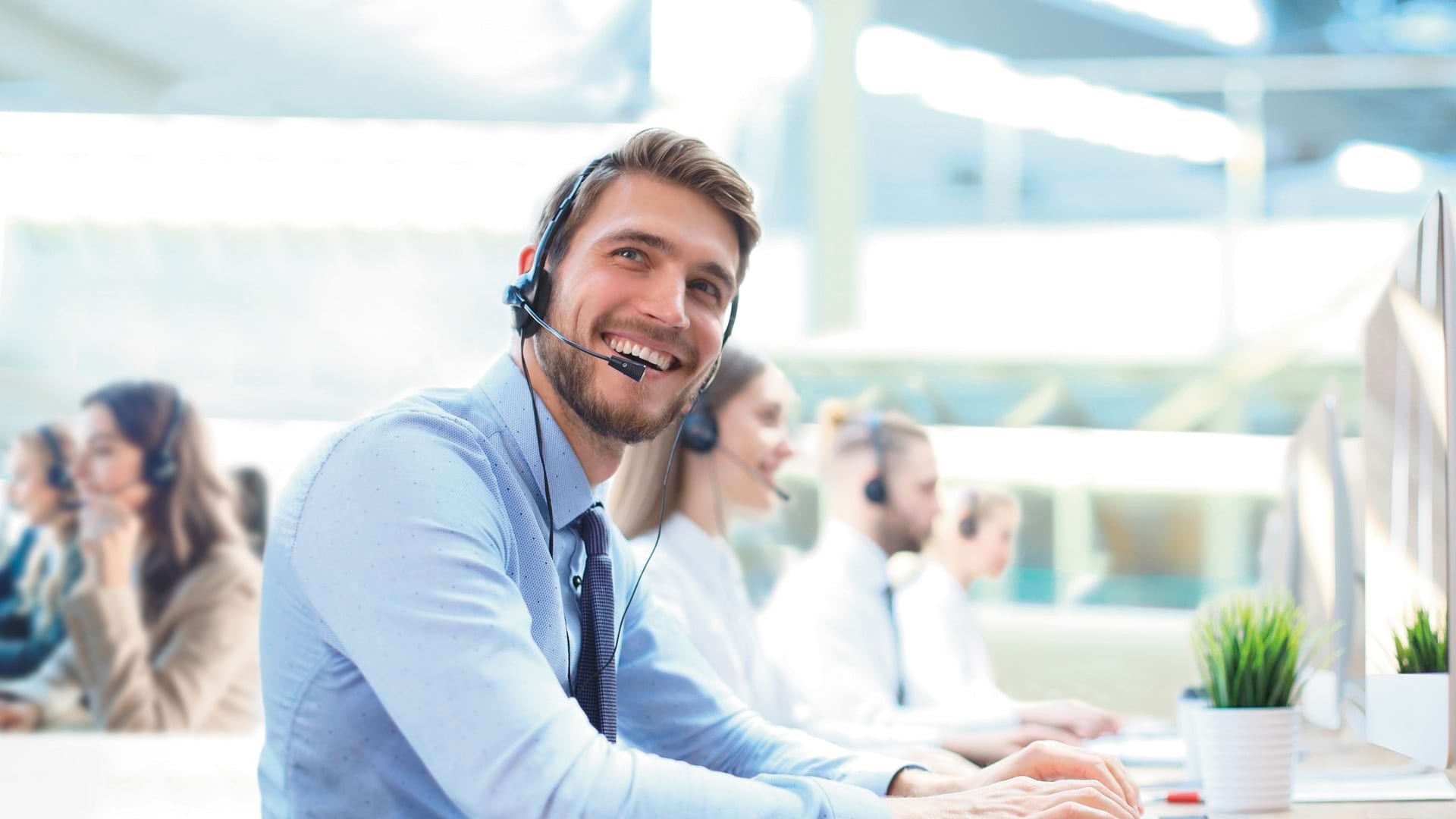 Call center representative smiling ARTICLE HERO IMAGE