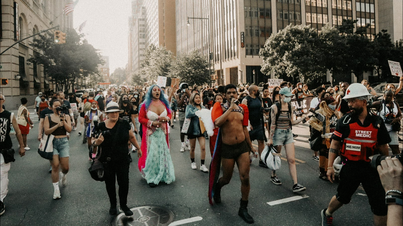 Black, Asian, and Blasian people marching together to celebrate Pride
