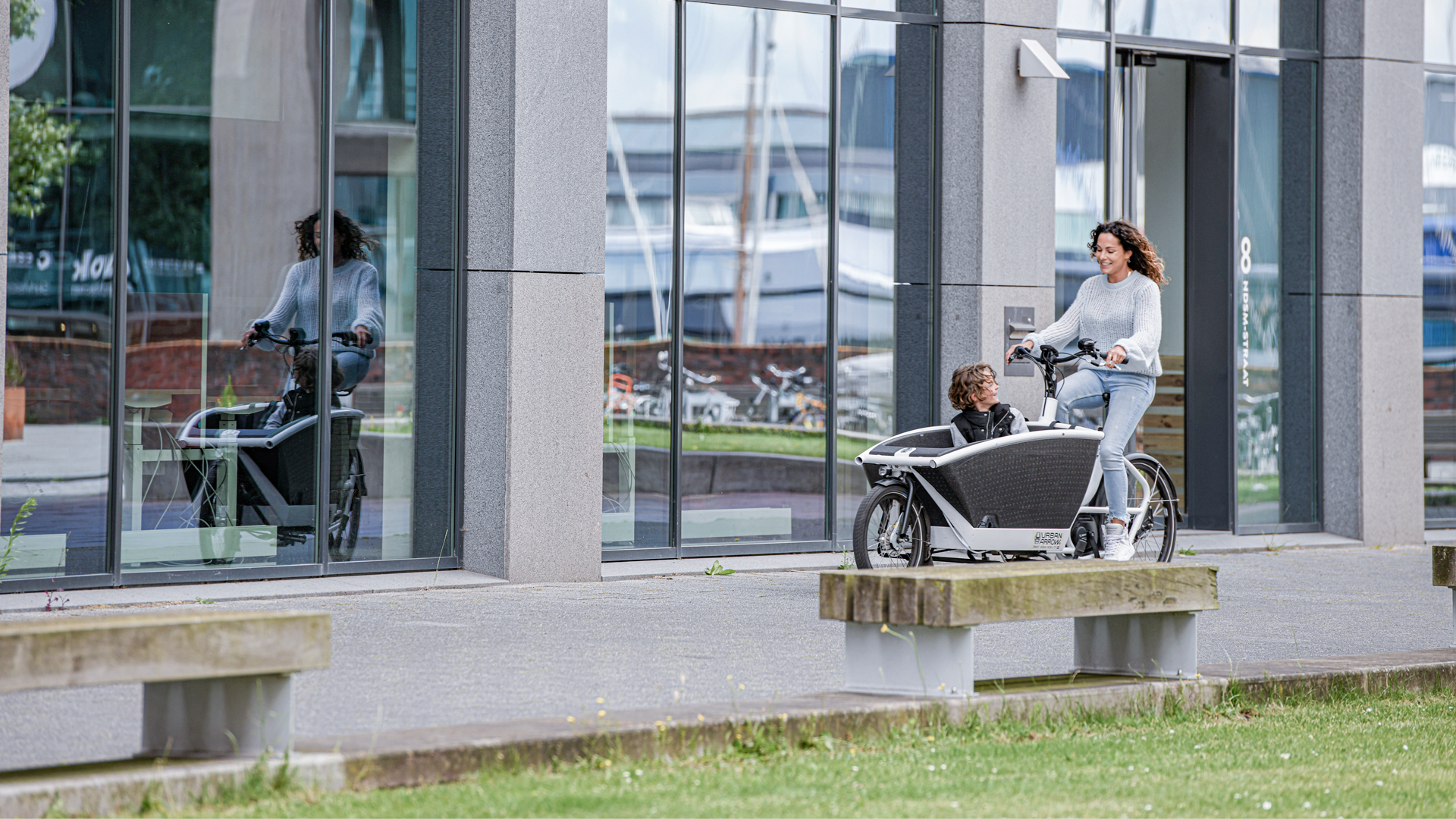 Woman on cargo e bike with child