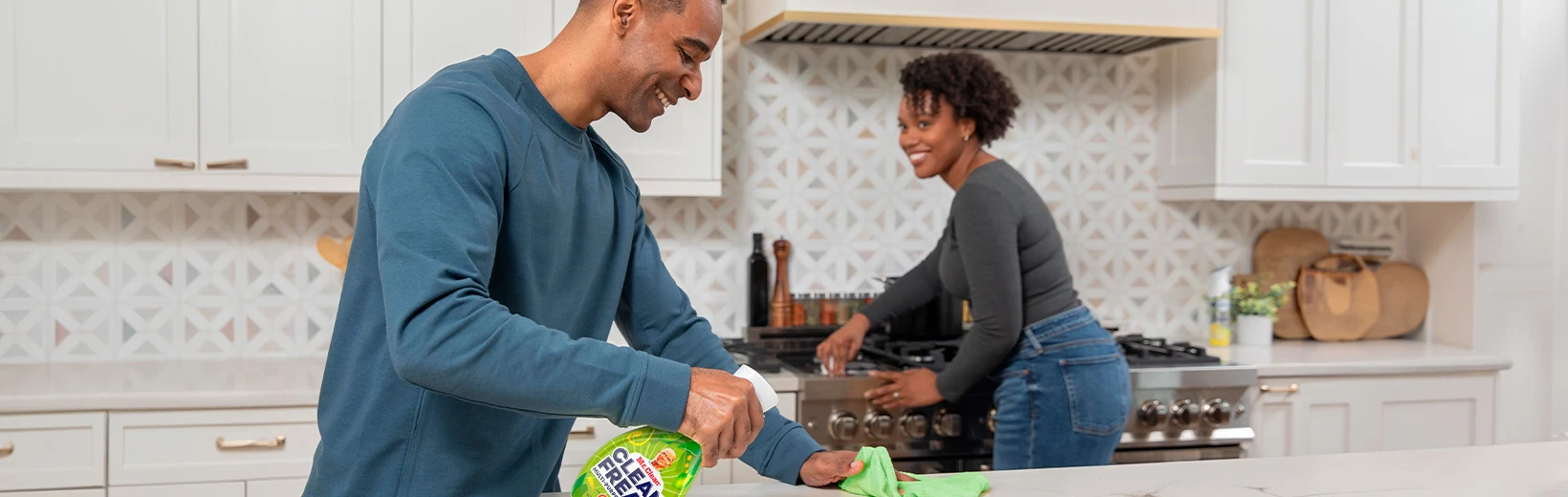 Husband and wife clean the kitchen with Clean Freak Mist with Gain Original